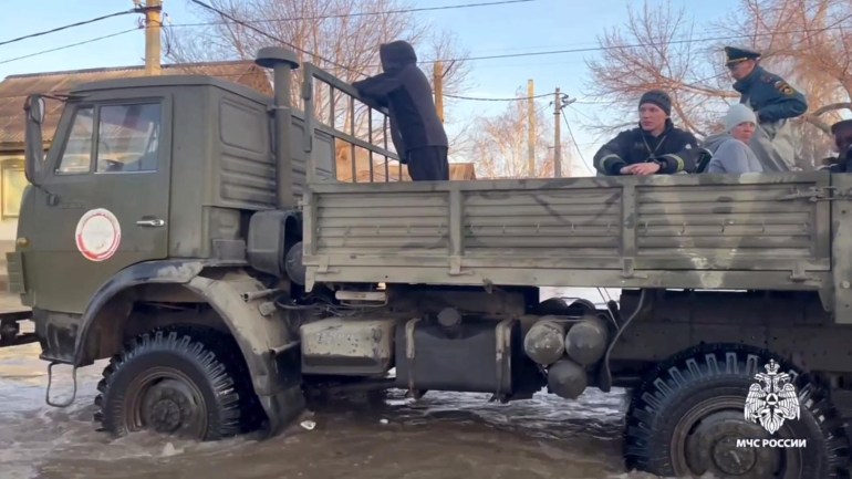 This photo taken from a video released by the Russian Emergency Situations Ministry on April 6, 2024 shows rescuers evacuate residents during a flood in the town of Orsk, Orenburg region, southeast of the southern tip of the Ural Mountains. - Russia said on April 6 it had evacuated more than 4,000 people in the Orenburg region, which lies near the Kazakhstan border, due to flooding after a dam burst.