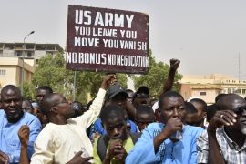 Protesters react as a man holds up a sign demanding that soldiers from the United States Army leave Niger without negotiation during a demonstration in Niamey, on April 13, 2024 [AFP]