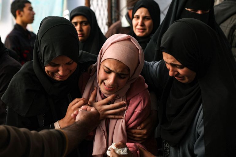 A woman reacts upon seeing the body of a relative killed in Israeli bombing in Rafah in the southern Gaza Strip on April 20
