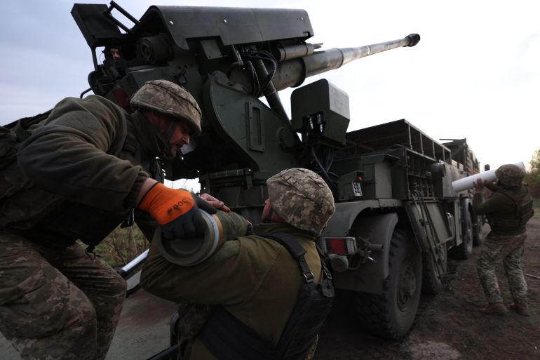 Ukrainian gunners loading a howitzer near the front line