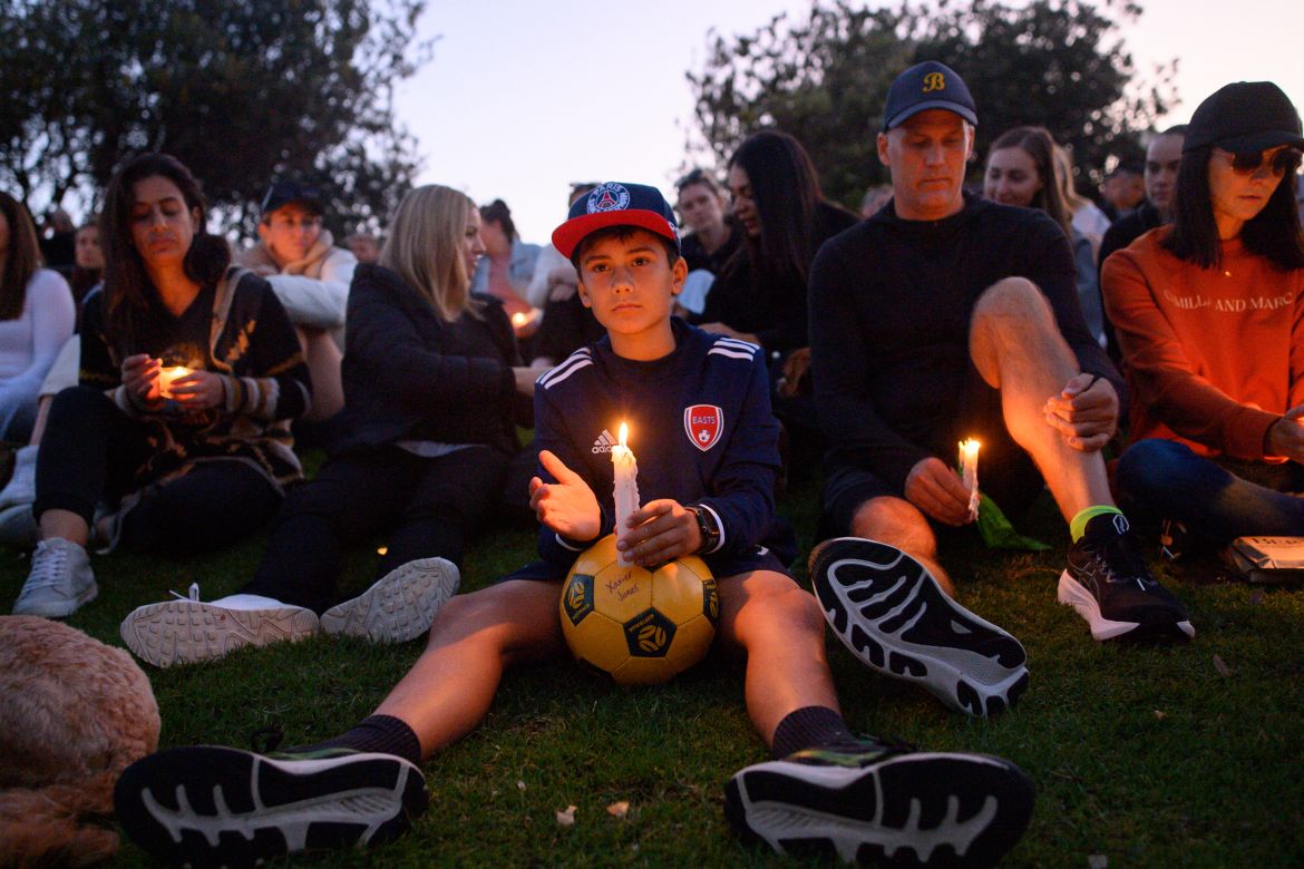 People attend a candlelight vigil for the victims of a stabbing attack at the Bondi Junction Westfield shopping centre in Sydney on April 21