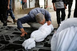 A man kisses the shrouded corpse of a child killed in overnight Israeli bombardment in the front of the morgue of a hospital in Rafah in the southern Gaza Strip on April 27, 2024. [AFP]