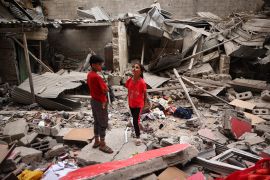 Palestinian children stand amid the debris of a house destroyed by overnight Israeli bombardment in Rafah in the southern Gaza Strip on April 27, 2024. [AFP] (AFP)