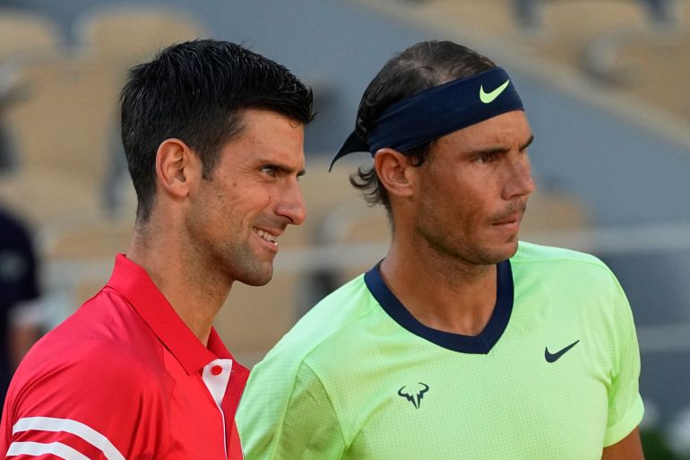 Novak Djokovic and Rafael Nadal pose for a photograph on the court at French Open.