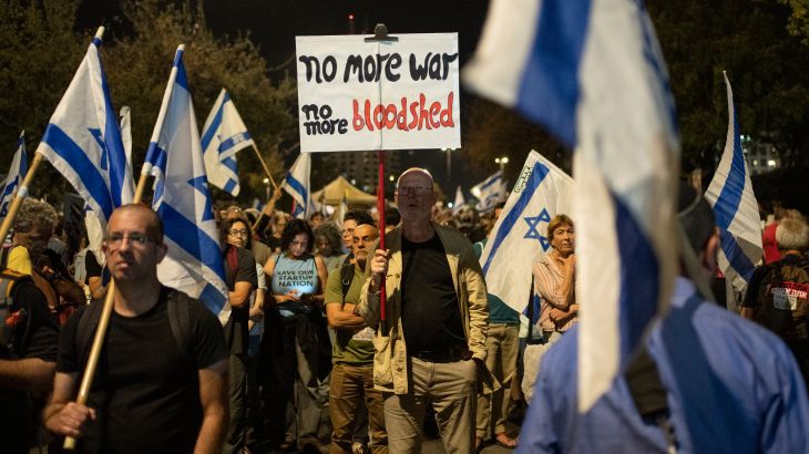 A man holds up a sign during a protest against Israeli Prime Minister Benjamin Netanyahu's government and to call for the release of hostages held in the Gaza Strip by the Hamas militant group near the Knesset, Israel's parliament, in Jerusalem