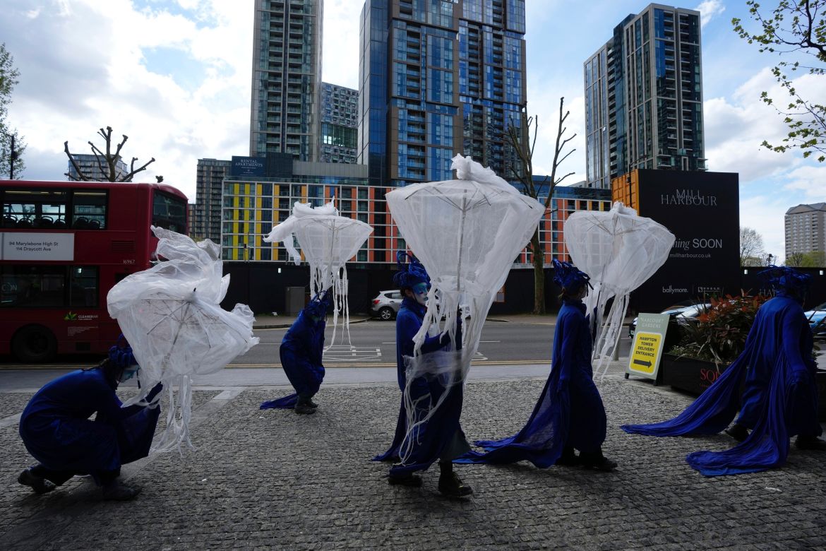 Protesters from Ocean Rebellion stage a demonstration against the deep sea mining conference outside the Hilton Hotel, in London, Wednesday, April 17