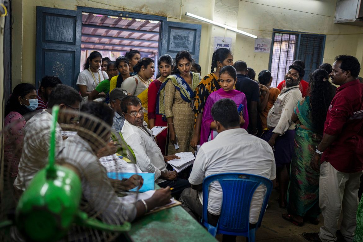 People crowd a polling booth to vote just before the polling ends during the first round of polling of India's national election in Chennai, southern Tamil Nadu state, Friday, April 19