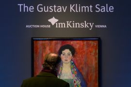 A man looks at the painting entitled Portrait of Miss Lieser prior to an auction in Vienna, Austria [Christian Bruna/AP]
