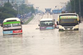 Public minibusses are submerged in the flooded streets of Dar es Salaam, Tanzania [AP]
