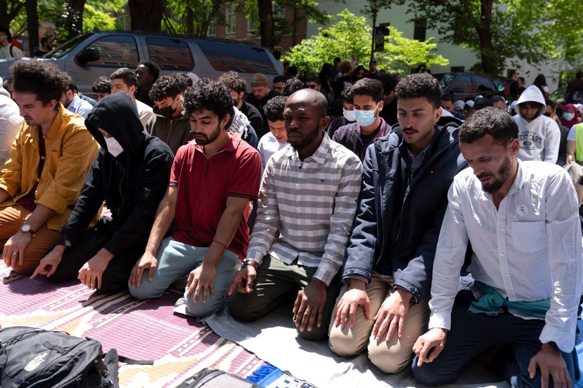 George Washington University students pray on the street after police close the students plaza during a pro-Palestinian protest over the Israel-Hamas war, Friday, April 26