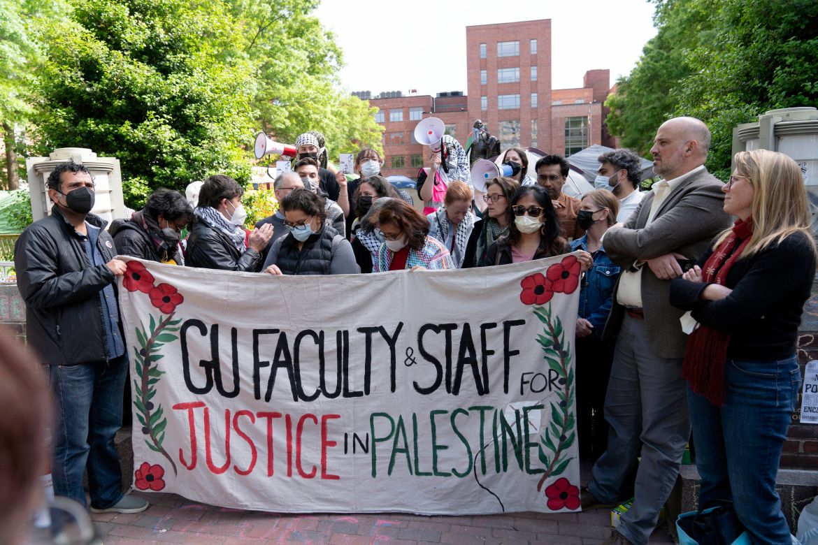 George Washington University professors Rochelle Davis, from right, and Will Youmans lead a group of professors during a pro-Palestinian protest over the Israel-Hamas war on Friday, April 26
