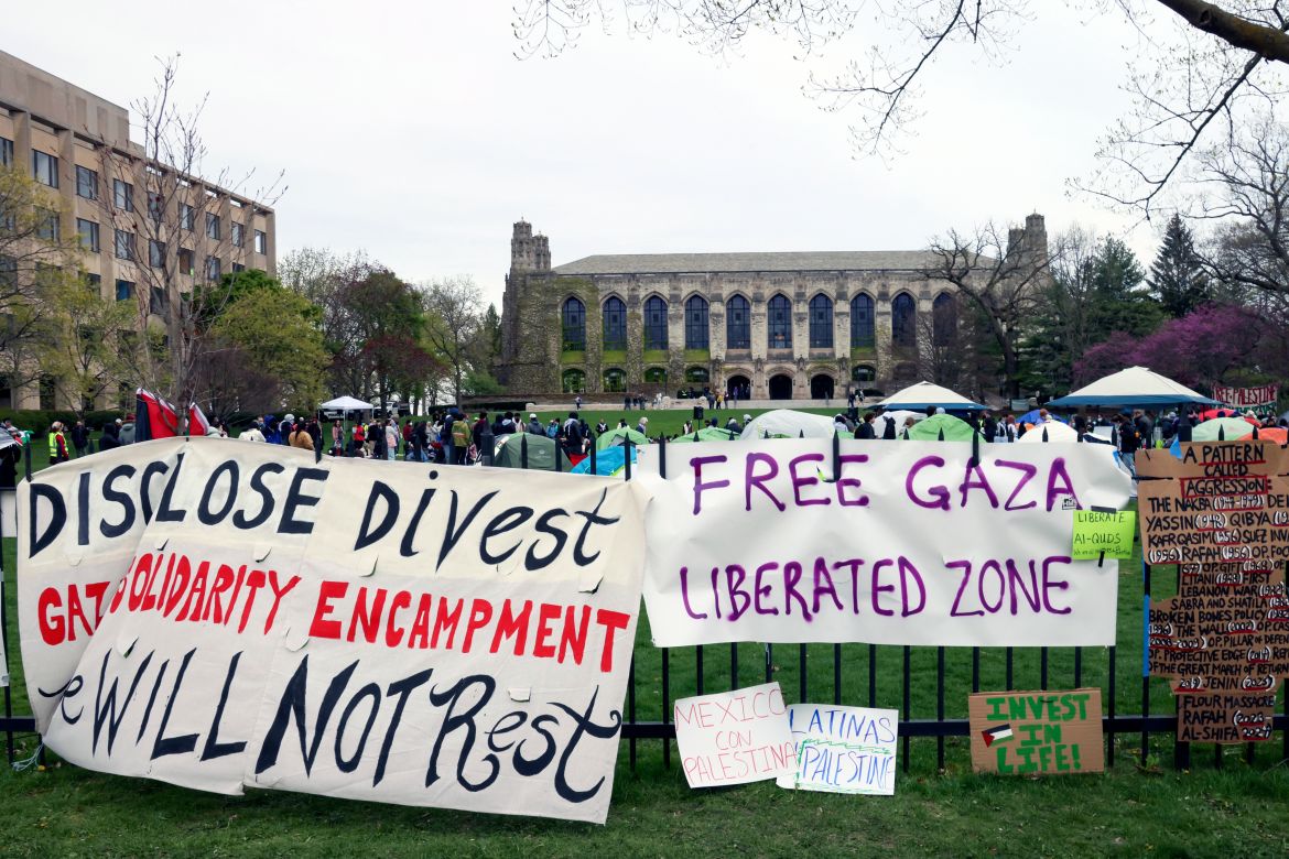 Signs are displayed outside a tent encampment at Northwestern University on Friday, April 26