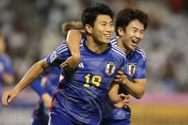 Japan&#039;s Mao Hosoya, left, celebrates after scoring during an Under 23 Asian Cup semifinal against Iraq [Hussein Sayed/AP]