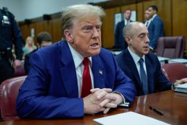 Former US President Donald Trump awaits the start of proceedings at Manhattan criminal court in New York [Eduardo Munoz/The Associated Press]