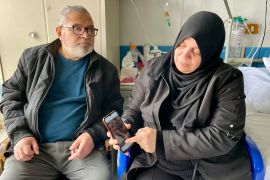 Hanan and Mazen at Fadi&#039;s bedside [Mosab Shawer/Al Jazeera]
