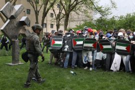 Pro-Palestinian student protesters link arms as Chicago police officers prepare to begin arrests at the Art Institute of Chicago in Chicago, Illinois, on May 4, 2024 [Alex Wroblewski/EPA]