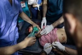 A Palestinian child injured following an Israeli strike is treated by medics at Kuwaiti Hospital in Rafah, the southern Gaza Strip, on May 8, 2024 [Haitham Imad/EPA]