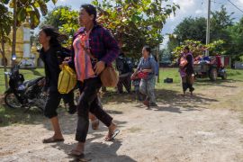 Civilians run for safety amid air strikes in Loikaw last November [Reuters]