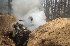 Ukrainian servicemen take part in radiation, chemical and biological hazard drills [File: Sofiia Gatilova/Reuters]