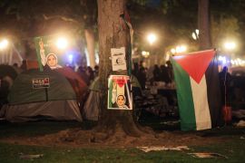 A Palestinian flag and posters are put up as people protest in support of Palestinians in Gaza at the University of Southern California (USC [File: David Swanson/Reuters]