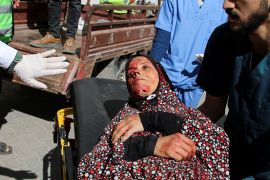 A Palestinian woman wounded in an Israeli strike is rushed into a hospital in Rafah [Hatem Khaled/Reuters]