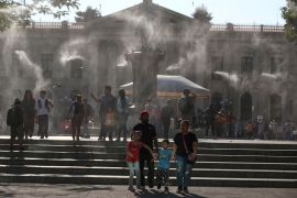 Water is sprayed to alleviate high temperatures caused by a heatwave, at the Gerardo Barrios square, in San Salvador, El Salvador [File: Jose Cabezas/Reuters]