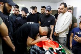 Mourners gather around the body of Samer Romana, who was killed by an Israeli raid, during his funeral in Nablus in the occupied West Bank on May 12, 2024 [Raneen Sawafta/Reuters]
