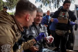 Military paramedics treat a wounded resident during an evacuation due to Russian shelling in the town of Vovchansk in Ukraine&#039;s Kharkiv region [Vyacheslav Madiyevskyy/Reuters]