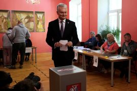 Lithuanian President Gitanas Nauseda casts his vote in Vilnius on Sunday [Ints Kalnins/Reuters]