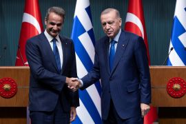 Turkey&#039;s President Tayyip Erdogan and Greek Prime Minister Kyriakos Mitsotakis pose after a news conference at the Presidential Palace in Ankara, Turkey [Umit Bektas/Reuters]