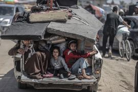 Children sit back on a truck as Palestinians with their packed belongings continue to depart from the eastern neighbourhoods of Rafah [Ali Jadallah/Anadolu Agency]
