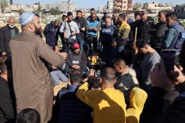 Al Jazeera&#039;s bureau chief in Gaza, Wael Dahdouh, centre, along with fellow journalists at the funeral of his son Hamza Dahdouh, also a journalist, who was killed in an Israeli strike in southern Gaza [File: Mohammed Abed/AFP]