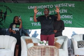 Former South African President Jacob Zuma and a member of the newly formed opposition party uMkhonto we Sizwe (MK) waves to supporters during an election rally outside his homestead in KwaZulu-Natal [File: Phill Magakoe/AFP]