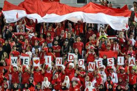 Indonesia&#039;s supporters cheer for their team during the U23 AFC Qatar 2024 Asian Cup third-place match between Iraq and Indonesia at Abdullah Bin Khalifa Stadium in Doha [Karim Jaafar/AFP]