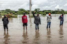 Residents inspect a road flooded by torrential rains in Kitengela, Kajiado, Kenya, on May 1, 2024 [Luis Tato/AFP]