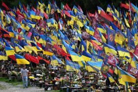 Ukrainian flags flutter among the graves at the Lychakiv Cemetery in Lviv [Yuriy Dyachyshyn/AFP]
