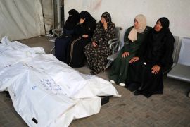 Relatives of Palestinians killed in Israeli bombing, mourn near their corpses in the yard of the al-Najjar hospital in Rafah [AFP]