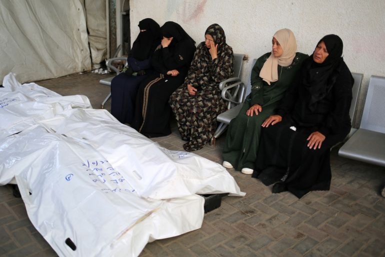 Relatives of Palestinians killed in Israeli bombing, mourn near their corpses in the yard of the al-Najjar hospital in Rafah