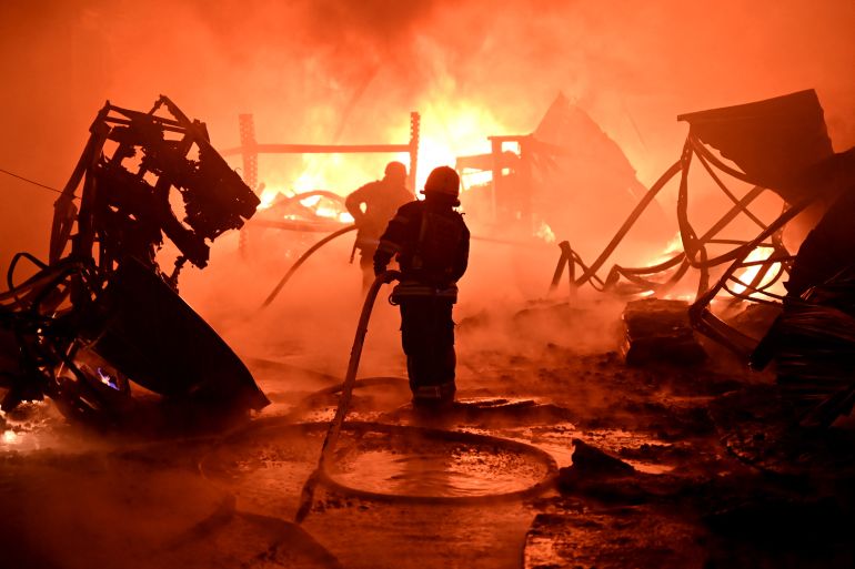Ukrainian firefighters work to extinguish a fire at the site of a drone attack on industrial facilities in Kharkiv on May 4, 2024, amid the Russian invasion of Ukraine. (Photo by SERGEY BOBOK / AFP)