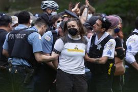 Police take demonstrators into custody on the campus of the Art Institute of Chicago in Chicago, Illinois [Scott Olson/Getty Images via AFP]