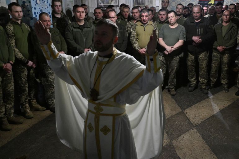 Servicemen of the 24th brigade of Ukrainian Army attend the Easter service in an undisclosed location in the Donetsk region