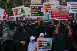 Indian Muslim women shout slogans against banning Muslim girls wearing a hijab from attending classes at some schools in the southern Indian state of Karnataka during a protest in Mumbai, India, Sunday, February 13, 2022 [Rafiq Maqbool/AP]