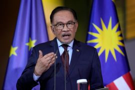 Malaysian Prime Minister Anwar Ibrahim has called on companies making large profits to share their gains with employees [Ebrahim Noroozi/AP]
