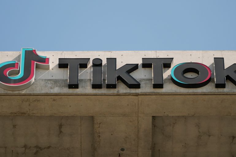 An image of the TikTok logo atop a building.