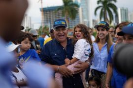 Opposition politician Jose Raul Mulino seen with his granddaughter Sofia at a rally in Panama City, is considered the favourite contender [File: Matias Delacroix/AP Photo]