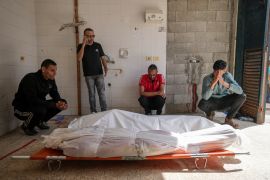 Palestinians react next to the bodies of their relatives who were killed in an Israeli airstrike in Gaza Stirp, at the Al Aqsa hospital in Deir el-Balah, Saturday [Abdel Kareem Hana/AP Photo]