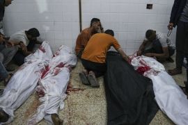Palestinians react next to the bodies of their relatives who were killed in an Israeli airstrike [Abdel Kareem Hana/AP Photo]