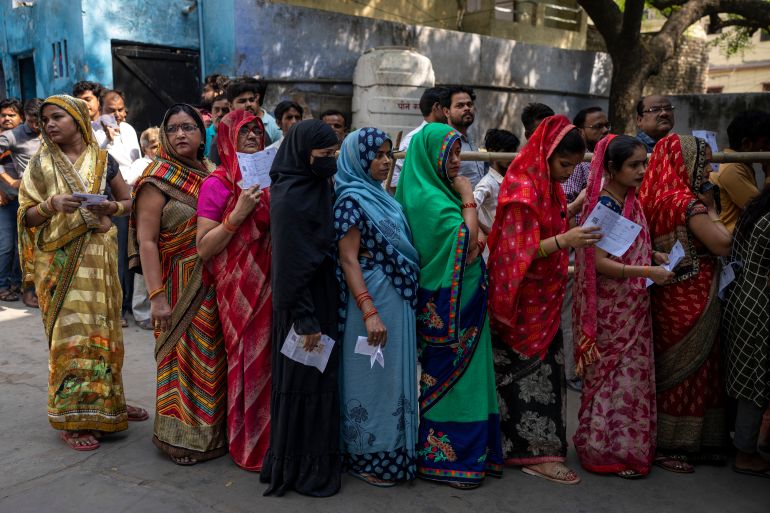 Women stand in queue to vote during the third round of voting in the six-week-long general election in Agra, Uttar Pradesh, India, Tuesday, May 7, 2024. (AP Photo/Altaf Qadri)
