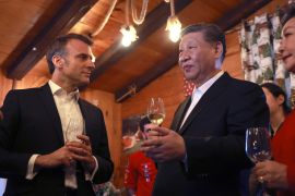 Chinese President Xi Jinping and French President Emmanuel Macron enjoy a drink together at a mountain restaurant in the Pyrenees [Aurelien Morissard/ Pool via AP]