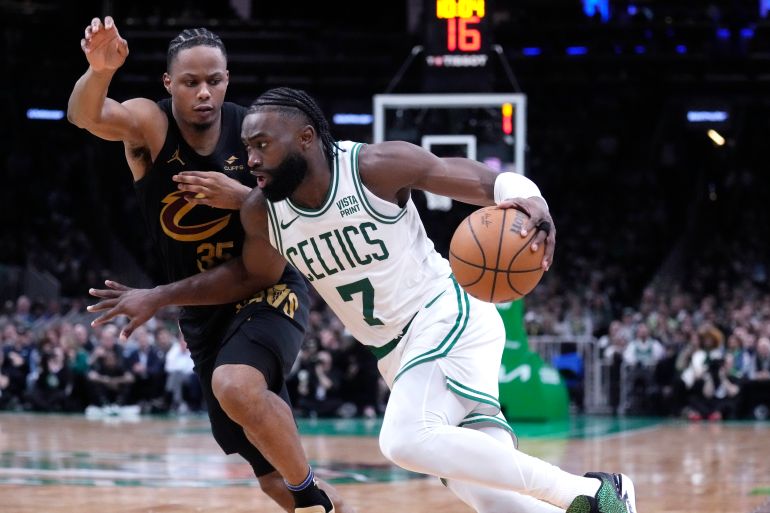 Boston Celtics guard Jaylen Brown (7) drives to the basket against Cleveland Cavaliers forward Isaac Okoro during the second half of Game 1 of an NBA basketball second-round playoff series Tuesday, May 7, 2024, in Boston. (AP Photo/Charles Krupa)